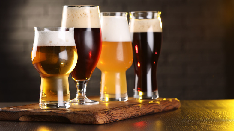 Different beers in different glasses on a board