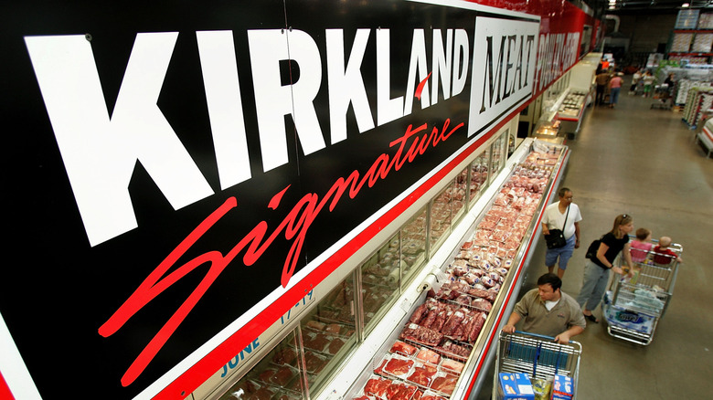 A Costco meat cooler is visible from a bird's-eye view from the Kirkland Signature Meat sign above