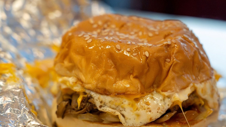 A Five Guys breakfast sandwich sits on a foil wrapper