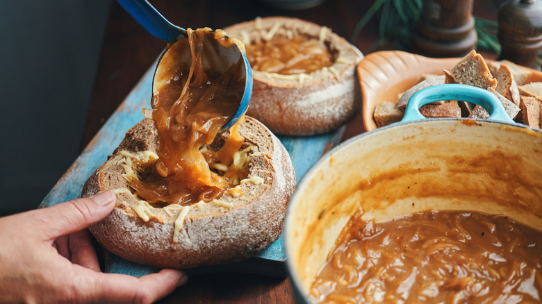 Preparing French onion soup for a bread bowl