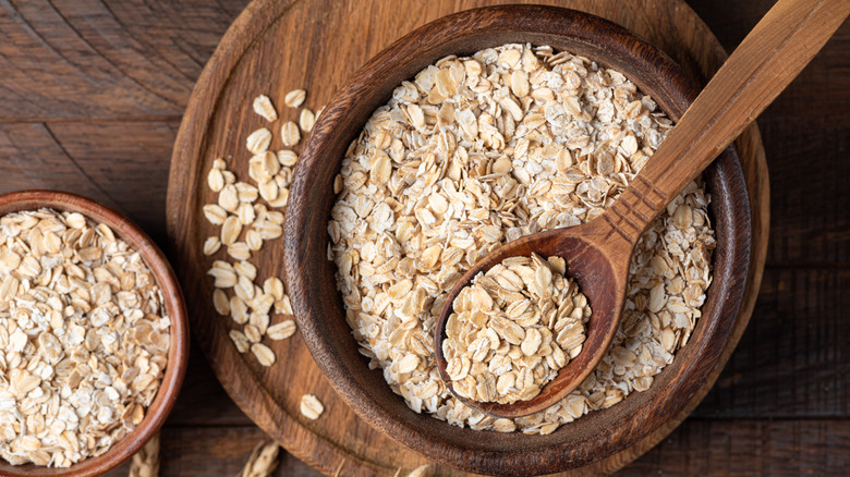 A wooden bowl of rolled oats.