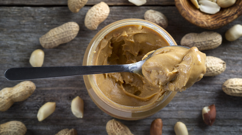 peanut butter spoonful on jar 