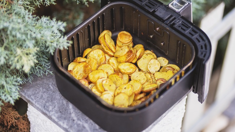 Roasted potatoes cooking in an air fryer