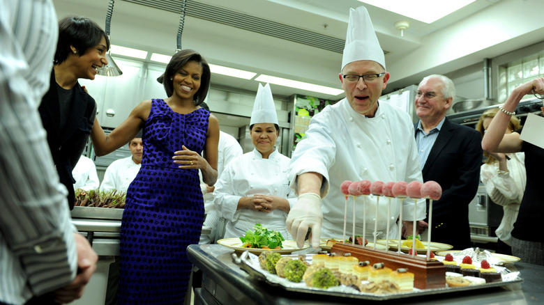 Michelle Obama with chefs displaying food in the White House kitchen