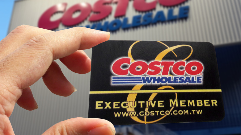 Person holding Costco membership card.