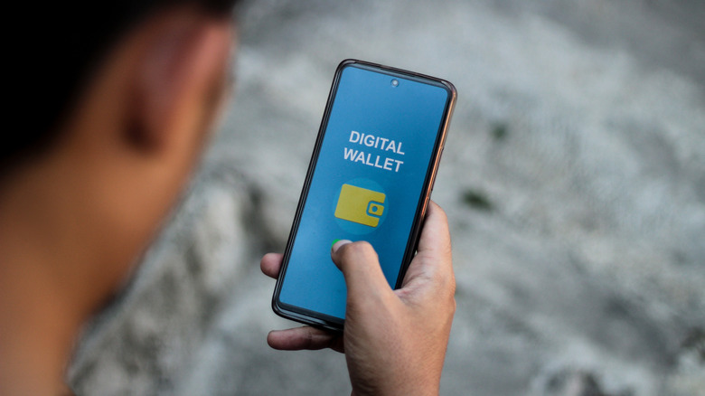 A person accessing a digital wallet on their phone