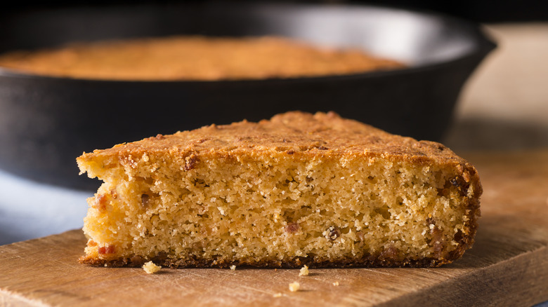 Slice of cornbread on a wooden serving board