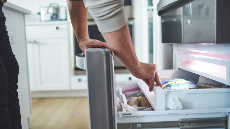 person opening up freezer door
