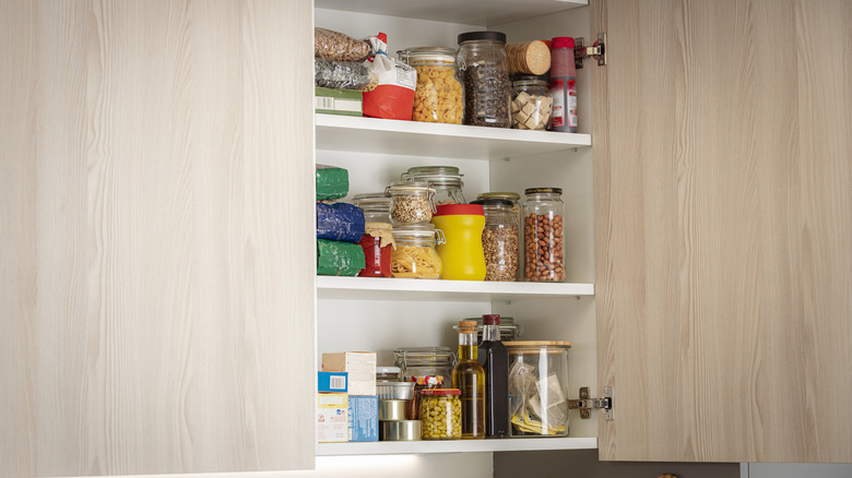 Open pantry door with dried goods