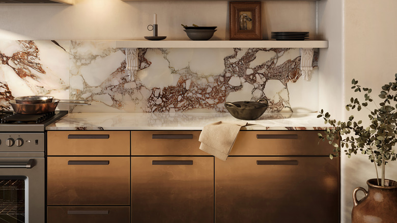 A modern, trendy kitchen with a marble backsplash.