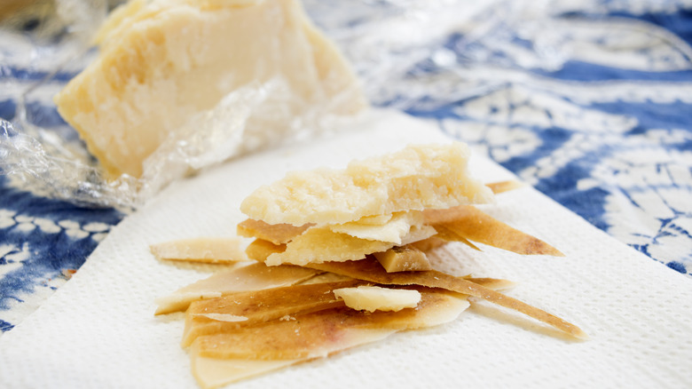Chunks and rinds off a parmesan cheese wheel