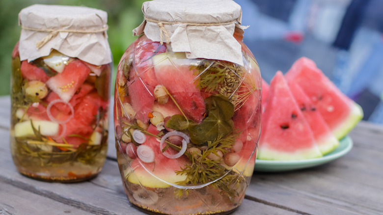 Jars of pickled watermelon rind on wooden table