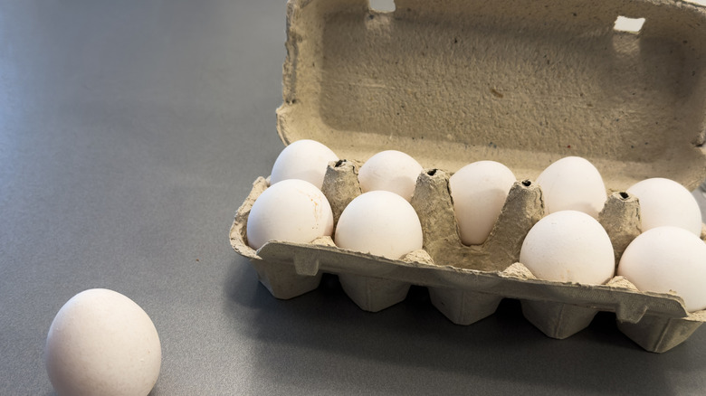 A cardboard egg carton sitting on the table