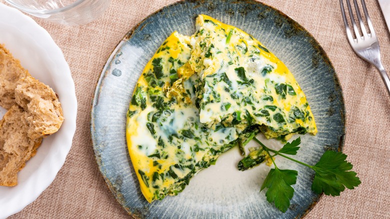 Spinach omelet on a blue ceramic plate