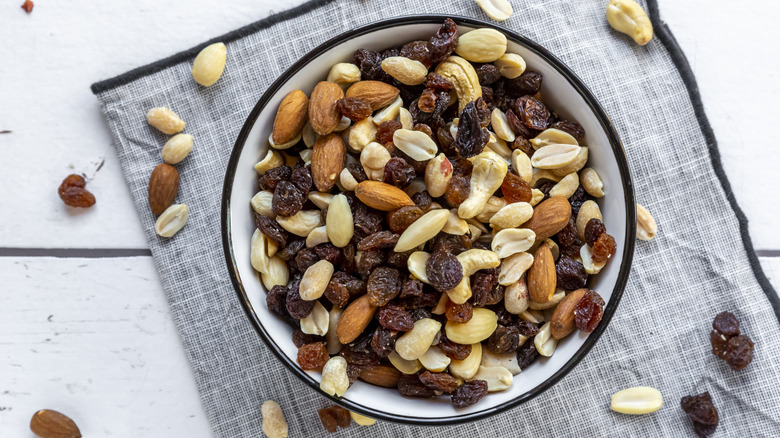 Bowl of trail mix with various nuts and raisins
