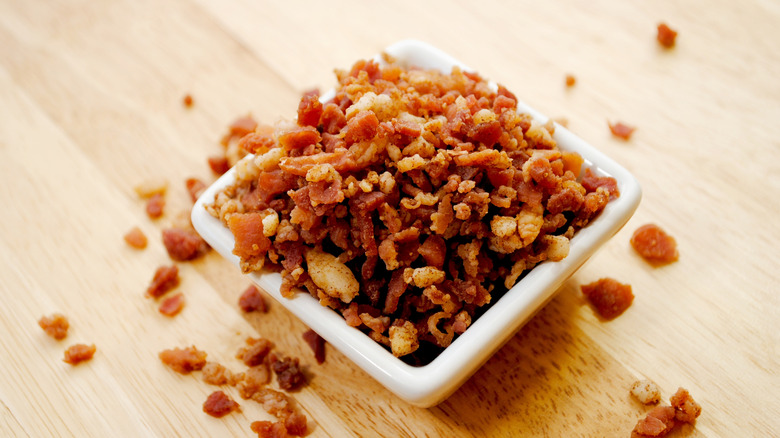 Small square dish full of bacon bits