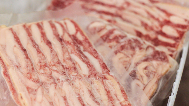 Packages of frozen bacon