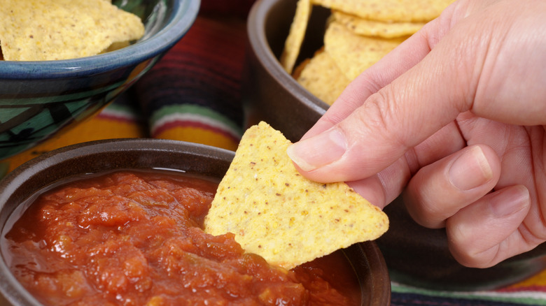 Dipping chip into salsa