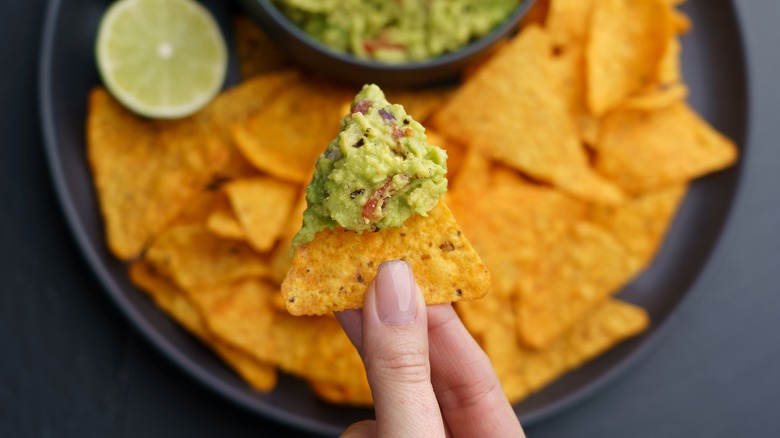 Woman holding a chip with gauc