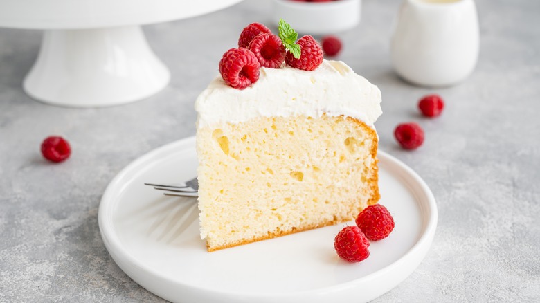 Slice of condensed milk soaked cake with raspberries