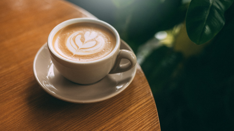 A cup of cappuccino on a table