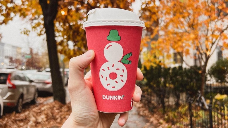 Hand holding dunkin donuts holiday beverage