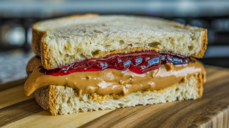 A peanut butter and jelly sandwich on a cutting board