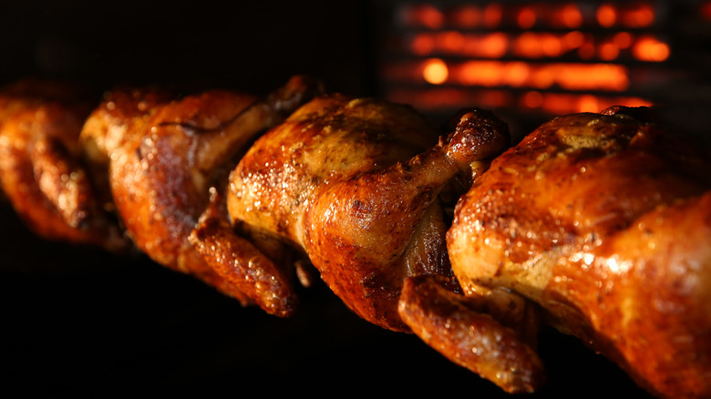 Rotisserie chickens with golden-brown skin