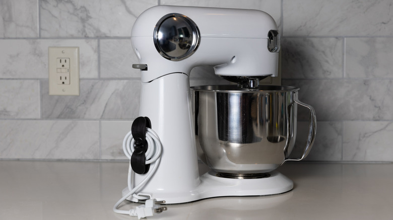 A white stand mixer on a kitchen countertop