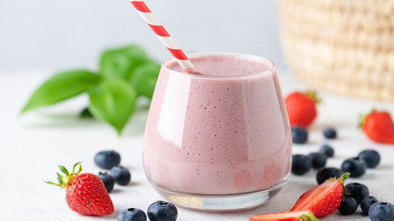 berrie smoothie in glass with striped straw