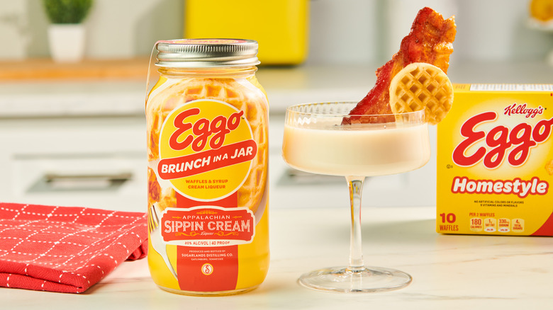 Eggo Brunch in a Jar next to cocktail with slice of bacon