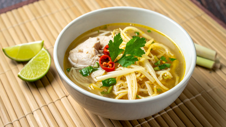 A bowl of soto ayam with lemongrass and lime