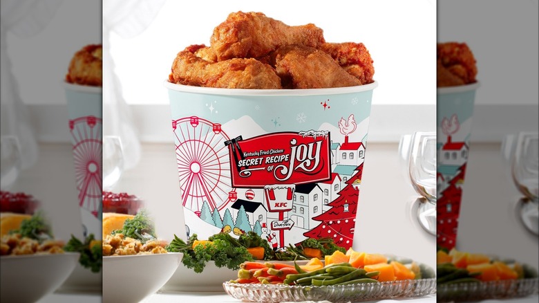 KFC's chicken leg, mashed potatoes, mac and cheese, and green beans together on a flat background