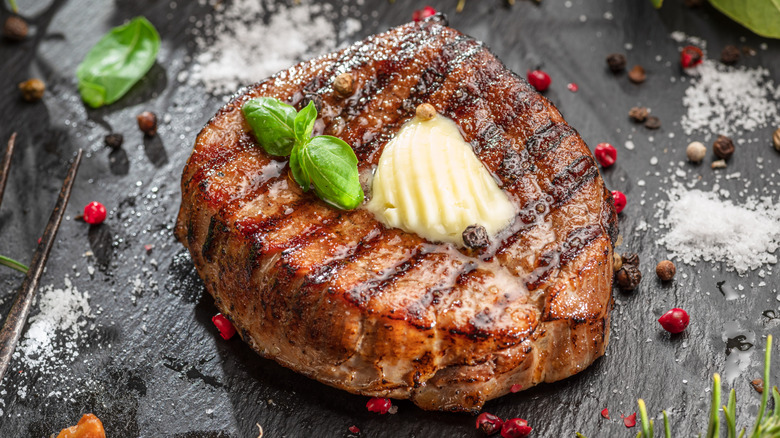 A grilled steak finished with a pat of butter