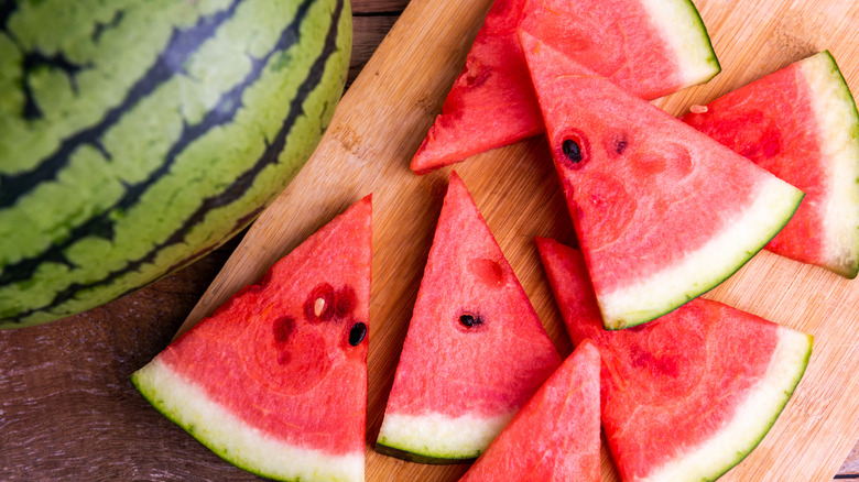 Slices of watermelon on wooden cutting board