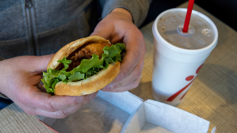 Someone holds a Chick-Fil-A sandwich.