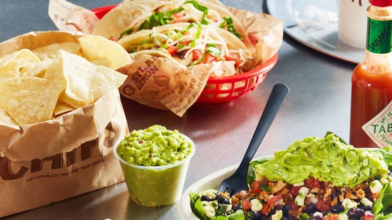 Chipotle chips, tacos, a burrito bowl, and guacamole