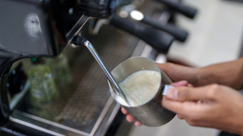Milk being aerated on a steam wand.