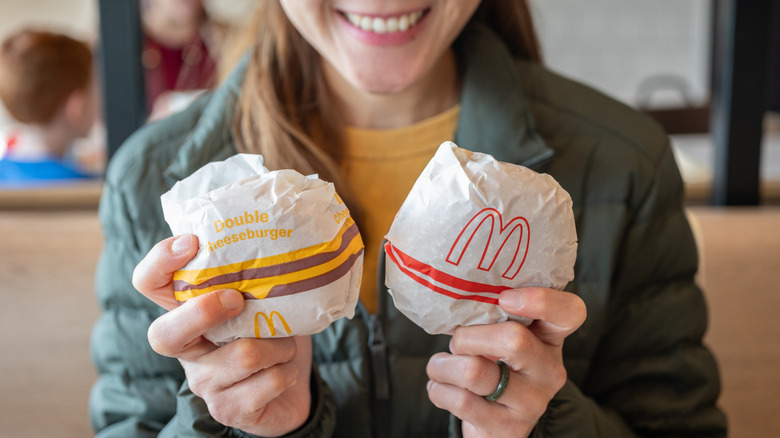 A diner holds up two different McDonald's burgers