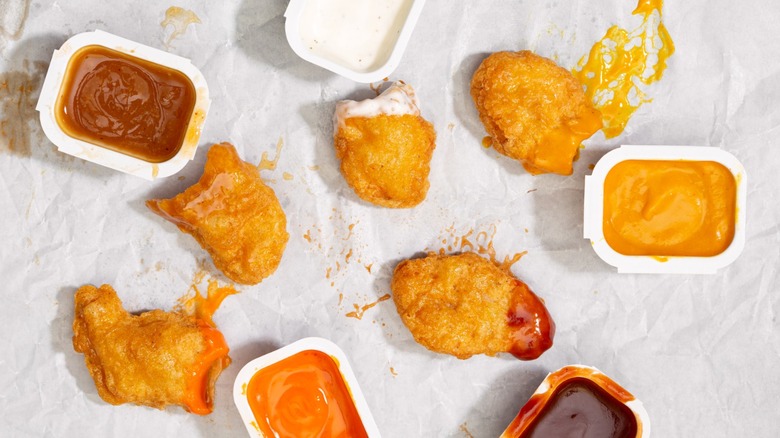 McNuggets surrounded by open sauce containers