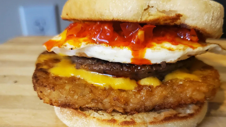 A Sausage & Egg McMuffin with a hash brown.