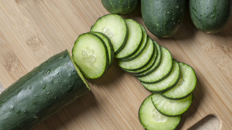 Sliced cucumbers on a cutting board.