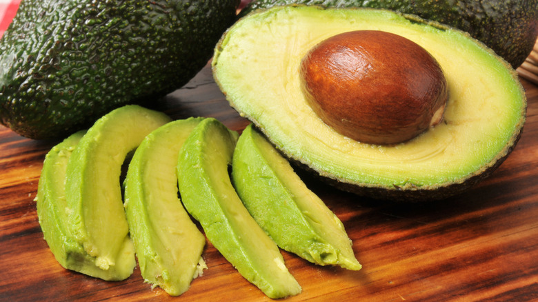 Sliced avocado on a cutting board.