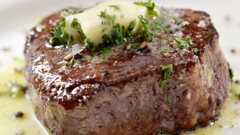 Steak topped with herb butter.