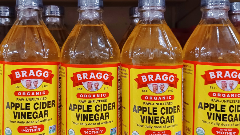 Bottles of Bragg organic apple cider vinegar at store