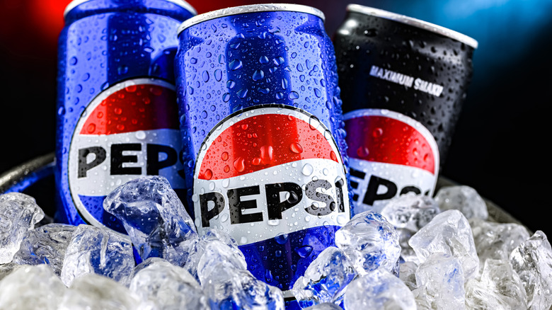 Three cans of Pepsi in ice