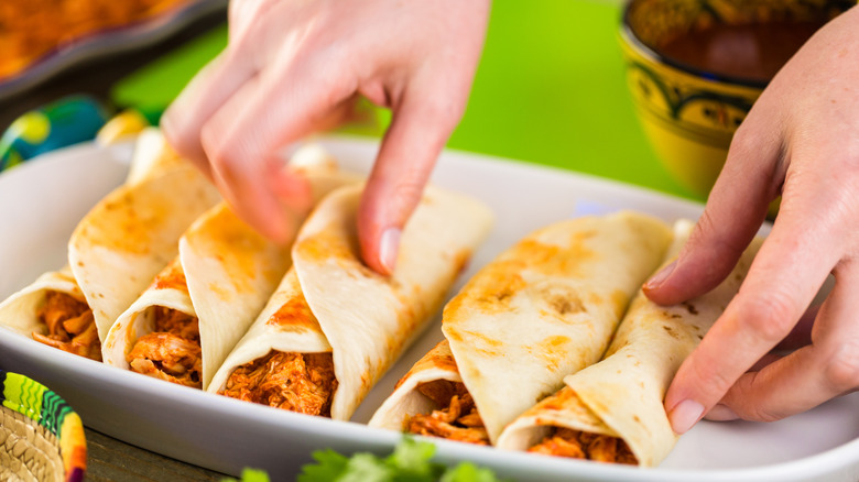 Person making enchiladas