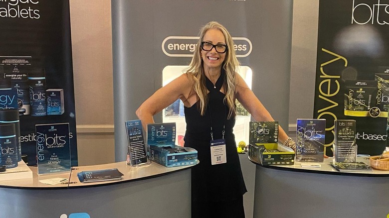Catharine Arnston smiling with Energybits display