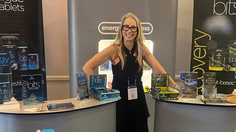 Catharine Arnston smiling with Energybits display