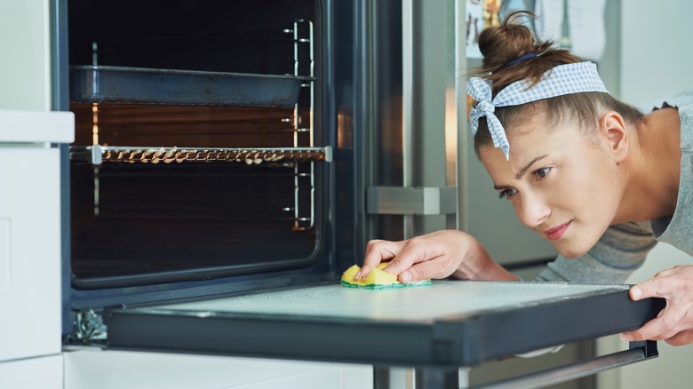 woman cleaning her oven